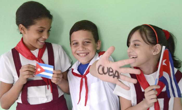 Estudiantes en una actividad escolar con símbolos de Cuba